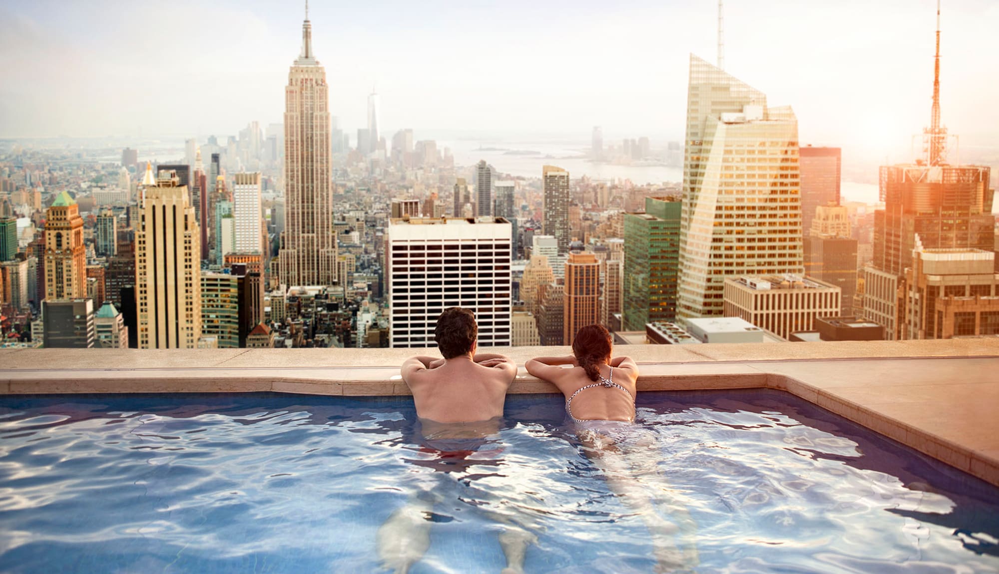 Transfer points to Travel Partners – couple in pool overlooking city