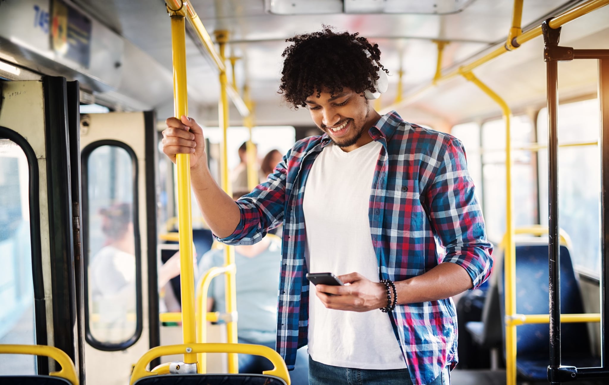 A man looking at his phone screen and smiling. A man looking at his phone screen and smiling.