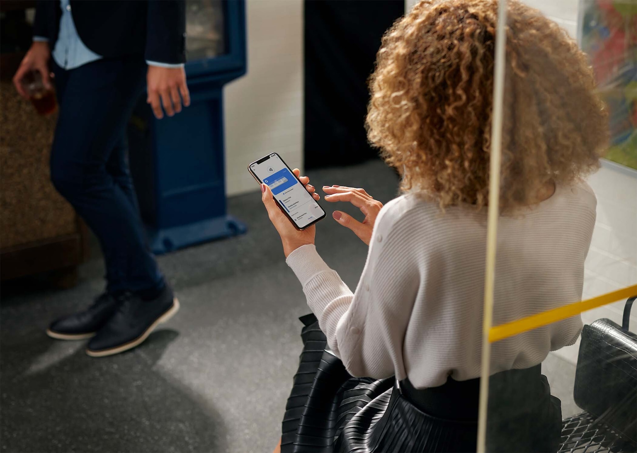A lady on the bus looking at her smartphone screen. A lady on the bus looking at her smartphone screen.