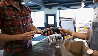 man_using_credit_card_in_eftpos_machine man_using_credit_card_in_eftpos_machine