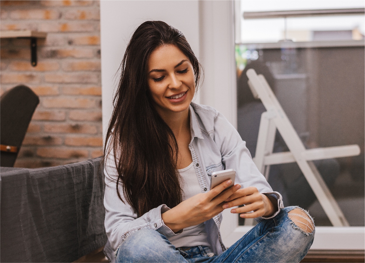 FAQs Woman on phone and laptop
