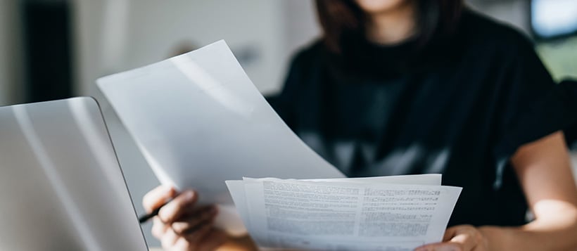 A business owner reviewing paperwork for asset based lending.