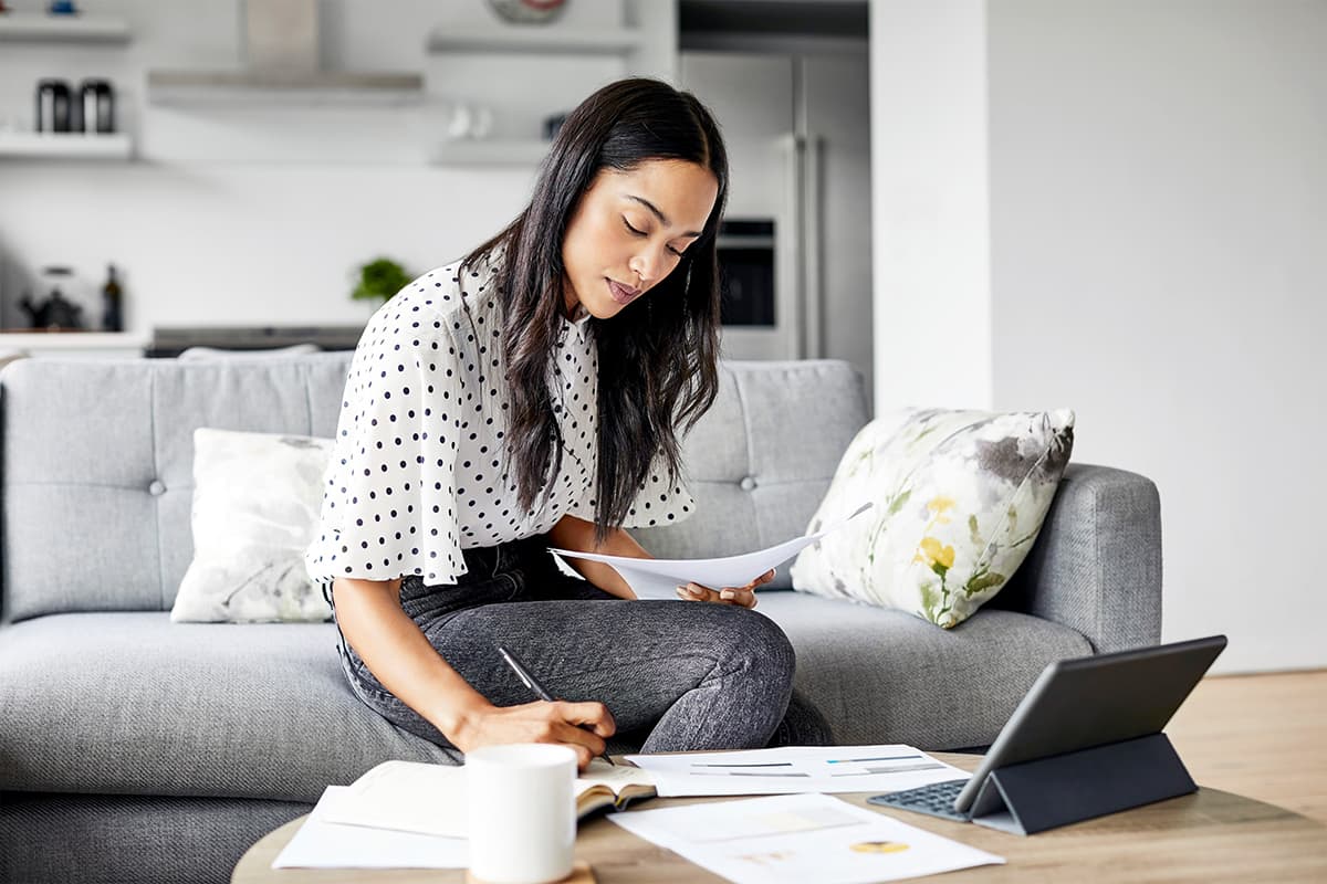 Someone looking at a bank statement at a desk