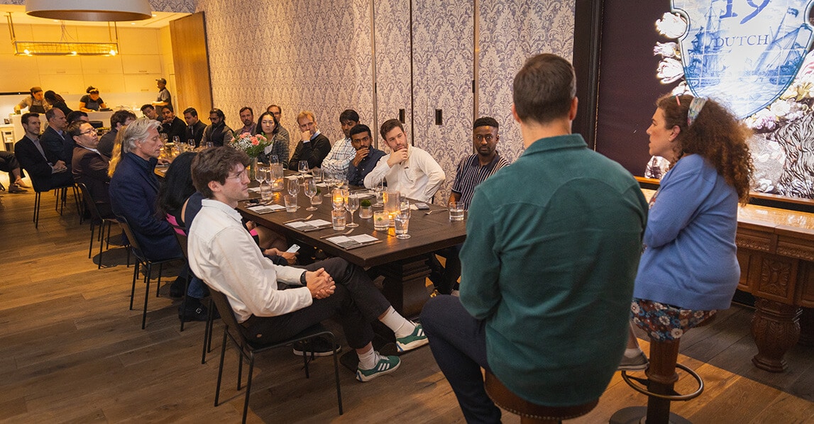 Gen AI and The Enterprise: An Amex Ventures Perspective People sitting at a table