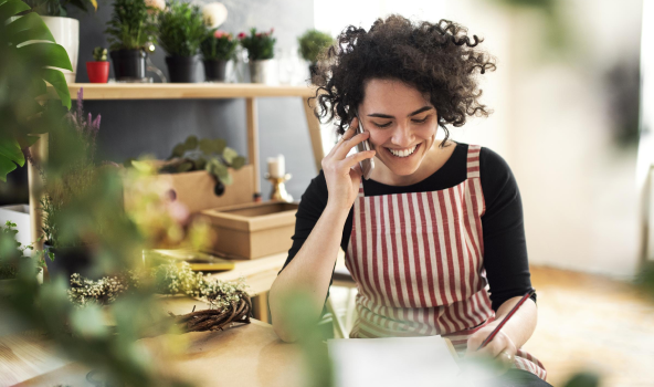 Plant store owner talking on phone
