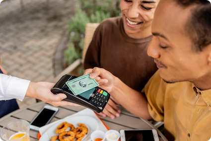 Couple making a payment with an American Express credit card.